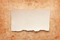 Ripped piece of paper on grunge paper background