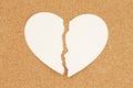 Ripped torn apart paper heart on a bulletin board for divorce or heartbroken concept Royalty Free Stock Photo