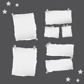 Ripped white note, notebook, copybook paper sheets, stars, stuck with sticky tape on black background.
