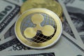 Ripple Coin and banknotes.Ripple crypto-currency on dollar notes