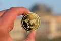 Ripple coin in a hand in front of german bundestag berlin