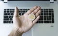 Ripple coin on a laptop keyboard closeup on a miner hand. Blockchain mining. Digital money and virtual cryptocurrency