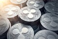 Ripple coins XRP in blurry closeup with sun flare.