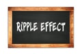 RIPPLE  EFFECT text written on wooden frame school blackboard Royalty Free Stock Photo