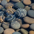 Ripple over smooth pebbles creates a mesmerizing pattern of concentric Royalty Free Stock Photo