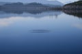 Ripple in still lake misty day,