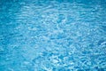 Ripple water in swimming pool with sun reflection. Blue water abstract background Royalty Free Stock Photo