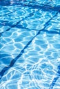 Ripple Water in swimming pool with sun reflection. Summer day at swimming pool. Background and texture concept.Vertical. Royalty Free Stock Photo