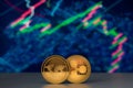 Cryptocurrency coins over financial charts on background Royalty Free Stock Photo