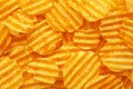 Rippled golden potato chips background with copy space for text Royalty Free Stock Photo