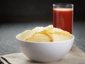 Rippled organic chips in white bowl wit tomato Royalty Free Stock Photo