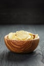 Rippled organic chips in wood bowl on wooden table Royalty Free Stock Photo