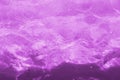 Rippled pattern of clean water in a purple swimming pool