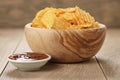 Rippled potato chips with paprika and bbq sauce in wooden bowl Royalty Free Stock Photo