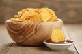 Rippled potato chips with paprika and bbq sauce in wooden bowl Royalty Free Stock Photo