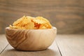 Rippled potato chips with paprika flavour in wooden bowl Royalty Free Stock Photo