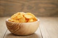 Rippled potato chips with paprika flavour in wooden bowl Royalty Free Stock Photo