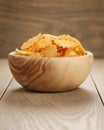 Rippled potato chips with paprika in wooden bowl Royalty Free Stock Photo