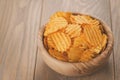 Rippled potato chips in wood bowl with copy space Royalty Free Stock Photo