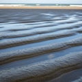 Between sand and water forms distinct lines and shadows, adding depth to Royalty Free Stock Photo