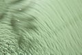 Rippled surface of clear water on light green background, top view Royalty Free Stock Photo