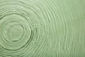 Rippled surface of clear water on light green background, top view Royalty Free Stock Photo