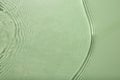 Rippled surface of clear water on light green background, top view Royalty Free Stock Photo