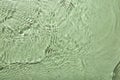 Rippled surface of clear water on light green background, top view Royalty Free Stock Photo