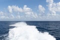 Rippled water trail from the moving boat or ship on sea. Foam of water created on the back of moving ship or ferry