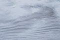 Rippled wet sand and water at the beach texture abstract background Royalty Free Stock Photo