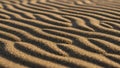 Ripples on a beach showcasing parallel wave like patterns formed by Royalty Free Stock Photo