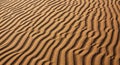 Ripples in fine, golden-brown sand create a mesmerizing pattern that covers the entire surface. The Royalty Free Stock Photo