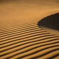 A desert landscape, showcasing natural sand formations shaped by wind. Royalty Free Stock Photo