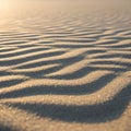Ripples in smooth, fine sand create a mesmerizing pattern, cast in soft, warm light fro Royalty Free Stock Photo