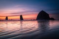 Ripples and sunset reflection in front of Cannon beach haystack Royalty Free Stock Photo