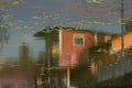 Reflection of houses in the water. Surface of a city pond. Royalty Free Stock Photo