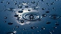 Ripples of water droplets creating concentric circles on a dark reflective surface Royalty Free Stock Photo