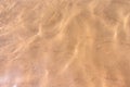 Ripples of water waves reflecting texture on a sandy beach bottom Royalty Free Stock Photo