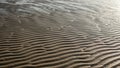 Ripples in wet sand create a dynamic pattern across the image Royalty Free Stock Photo