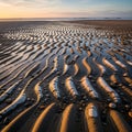 Ripples in wet sand create intricate wave like patterns at low tide Royalty Free Stock Photo