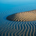 Ripples in wet sand create a series of parallel, wavy lines under soft Royalty Free Stock Photo