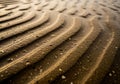 Ripples in wet sand create a textured pattern, capturing the effect Royalty Free Stock Photo