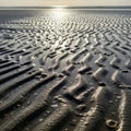 Ripples in wet sand create a textured undulating pattern along the beach Royalty Free Stock Photo