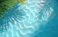 Rippling blue water surface shows transparent palm leaf shadows. Sunlight creates subtle highlights, reflections. Top view of spa Royalty Free Stock Photo