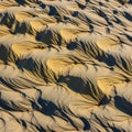 Rippling patterns in sand dunes showcase intricate textures formed by Royalty Free Stock Photo
