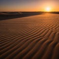 Patterns of sand dunes stretch across the landscape under a setting Royalty Free Stock Photo