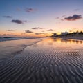 Rippling sand patterns at low tide reflecting a vibrant sunset Royalty Free Stock Photo