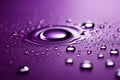 Rippling water drop on purple surface with droplets around it. Isolated on purple background Royalty Free Stock Photo
