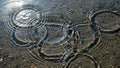 Rippling water over a pebbled surface creates concentric circles Royalty Free Stock Photo