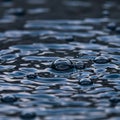 Rippling water with several bubbles captured in close-up, creating a textured surface. Royalty Free Stock Photo